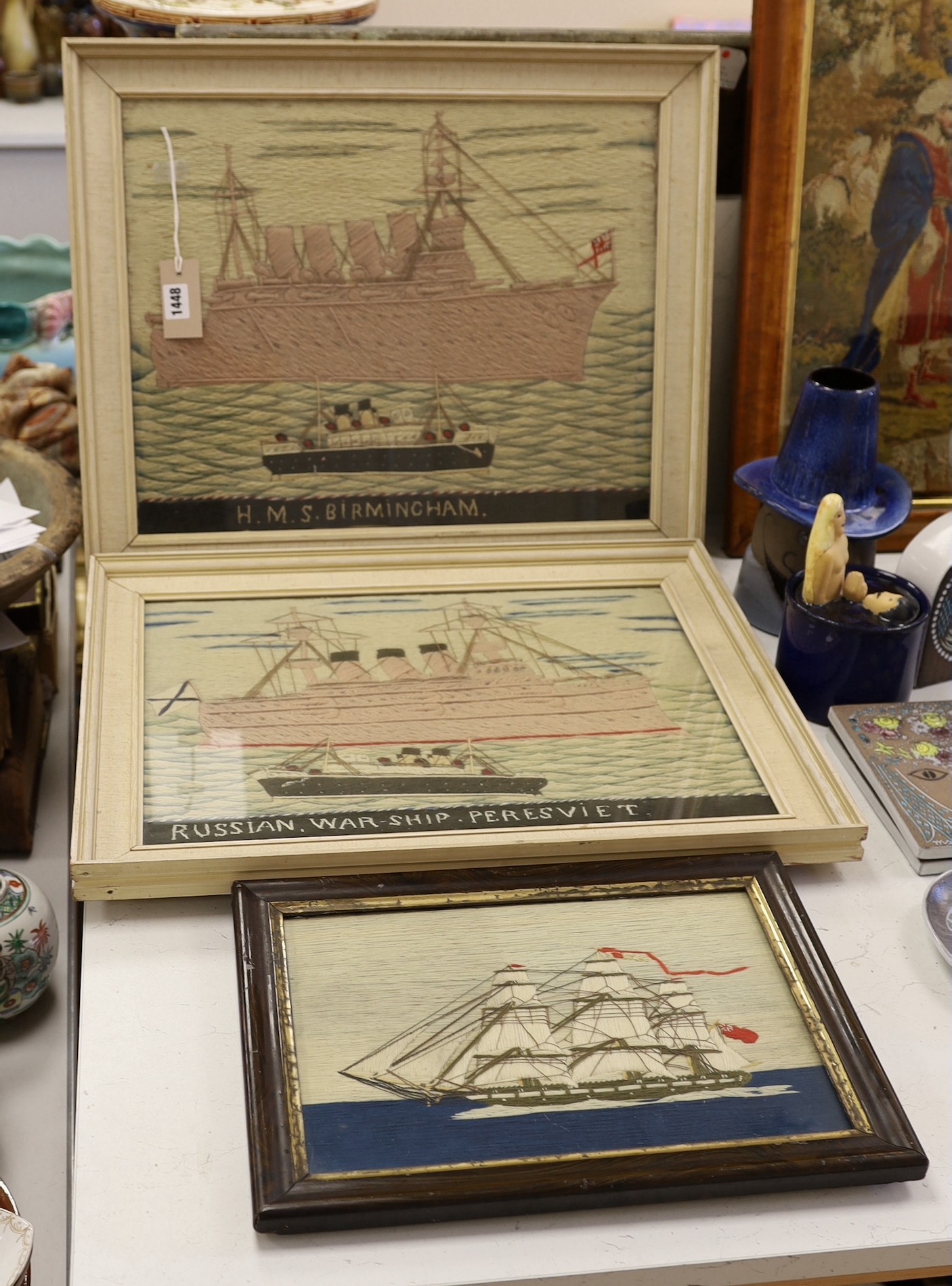 A pair of woolwork ship portraits, HMS Birmingham and Russian Warship Peresviet, a smaller woolwork of a sailing boat and a Berlin woolwork of a biblical scene, HMS Birmingham: 49cms wide x 39cm high